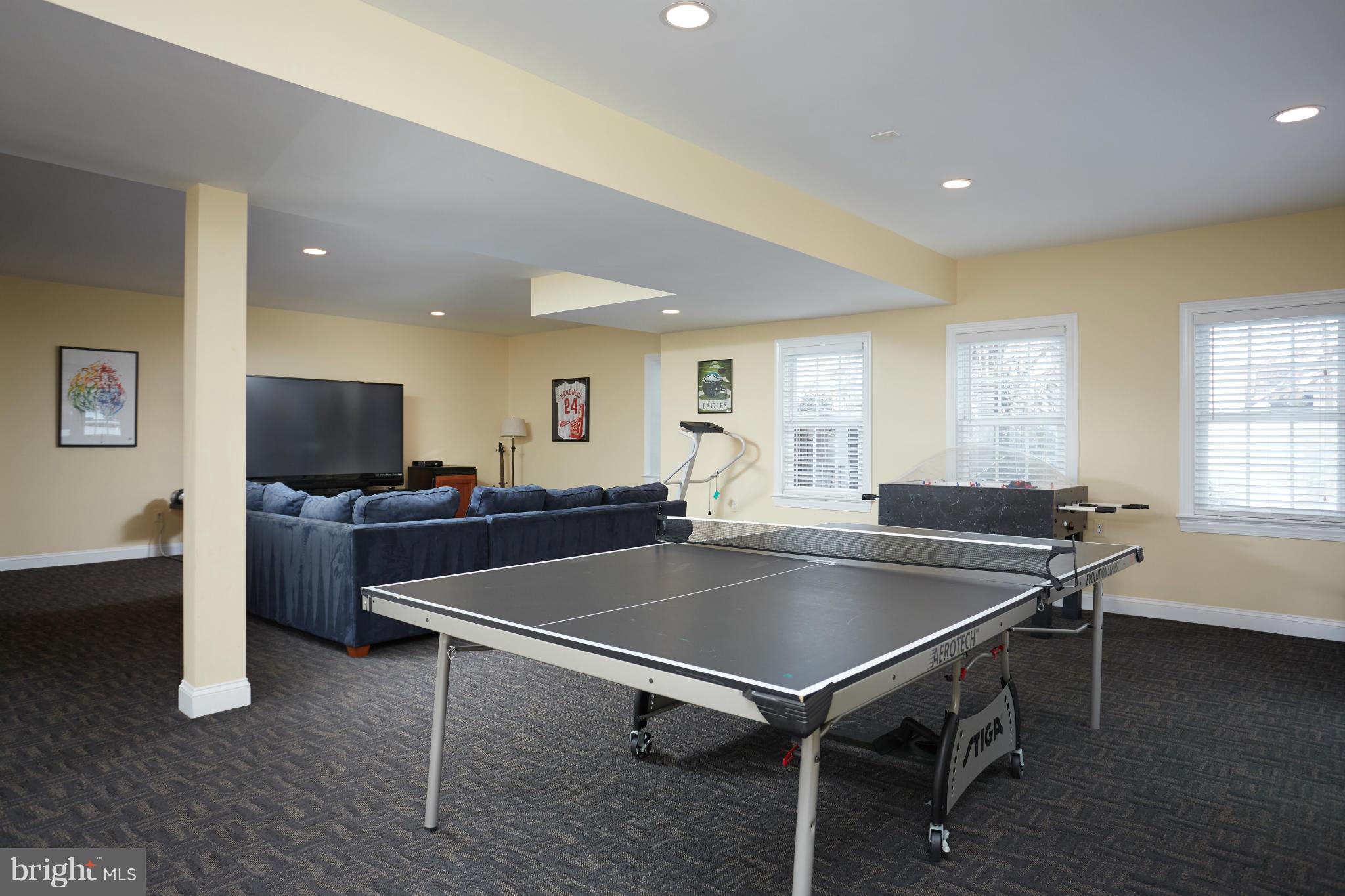 12636 Greenbriar Road Potomac, MD 20854 - Photo 24 of 30 a living room with a table and a flat screen tv
