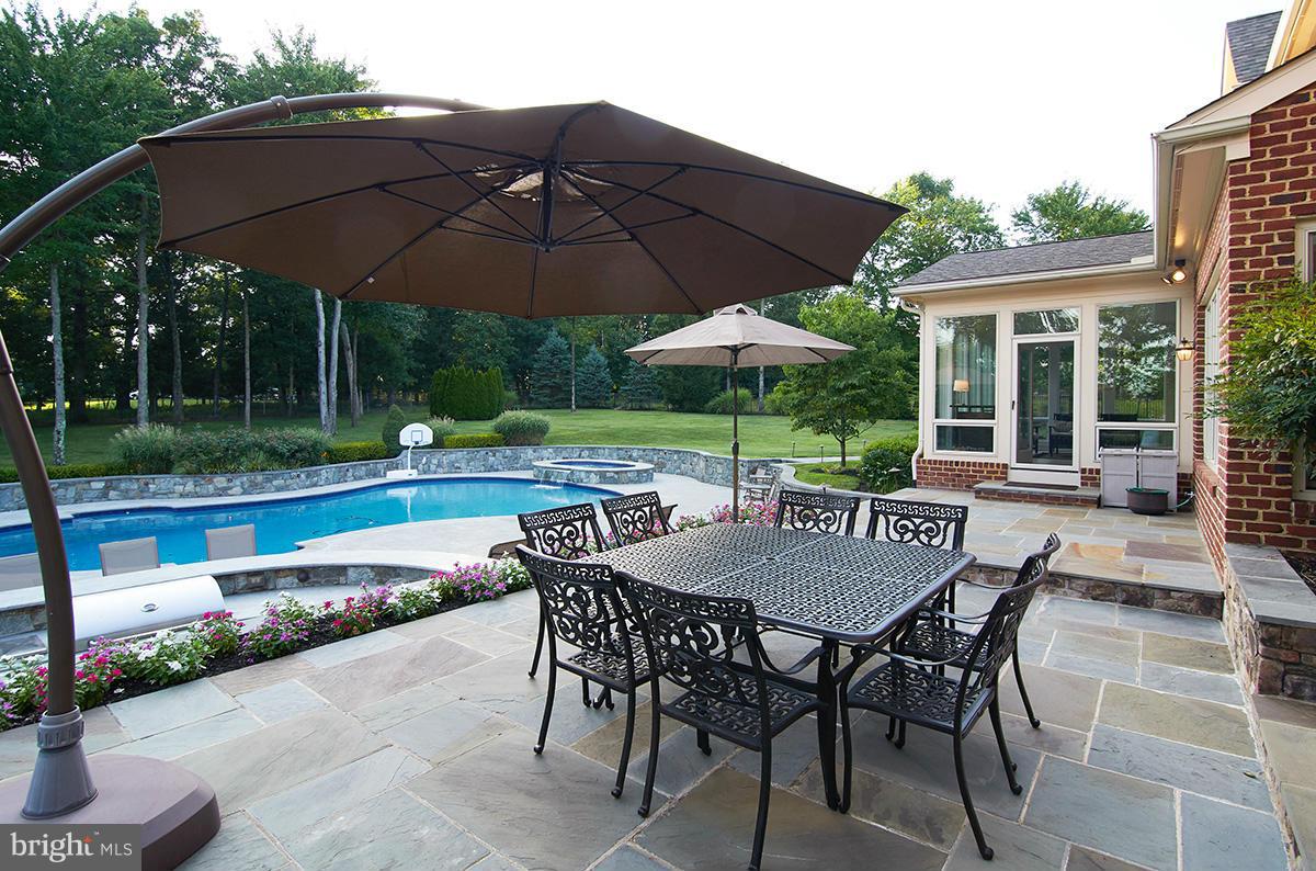 12636 Greenbriar Road Potomac, MD 20854 - Photo 26 of 30 a view of patio with chairs and table under an umbrella
