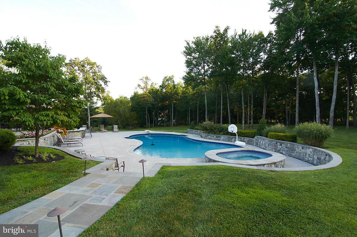 12636 Greenbriar Road Potomac, MD 20854 - Photo 28 of 30 a view of a fountain in front of a house with a big yard and palm trees