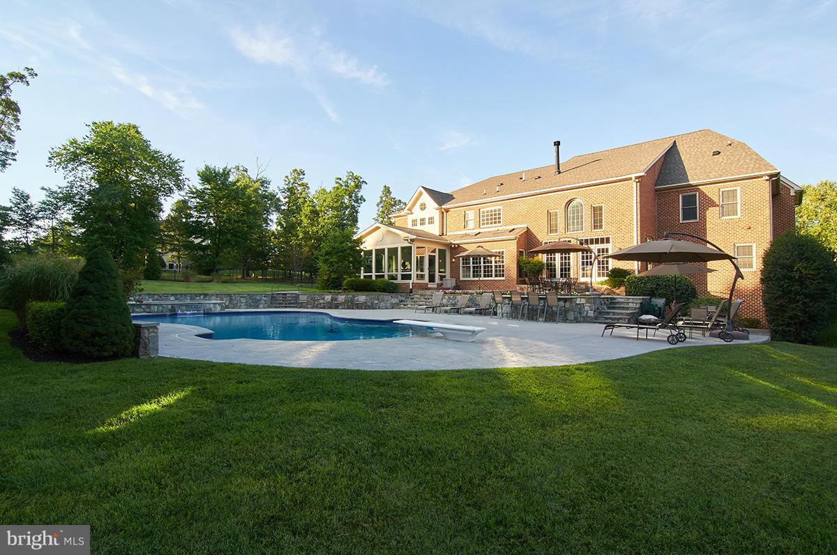 12636 Greenbriar Road Potomac, MD 20854 - Photo 29 of 30 a swimming pool with outdoor seating and yard