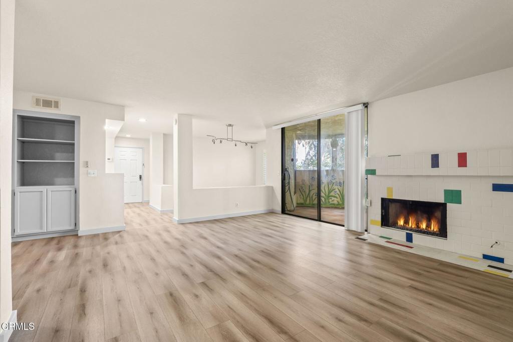 2202 Martinique Lane Oxnard, CA 93035 - Photo 11 of 39 a view of an empty room with wooden floor fireplace and a window