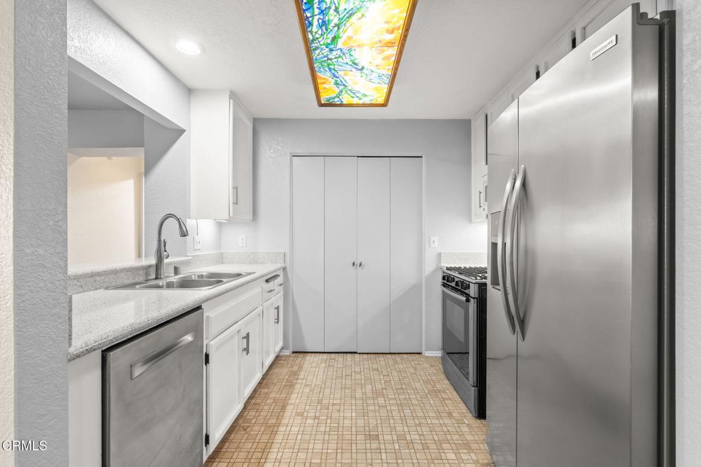 2202 Martinique Lane Oxnard, CA 93035 - Photo 15 of 39 a kitchen with a refrigerator and a sink