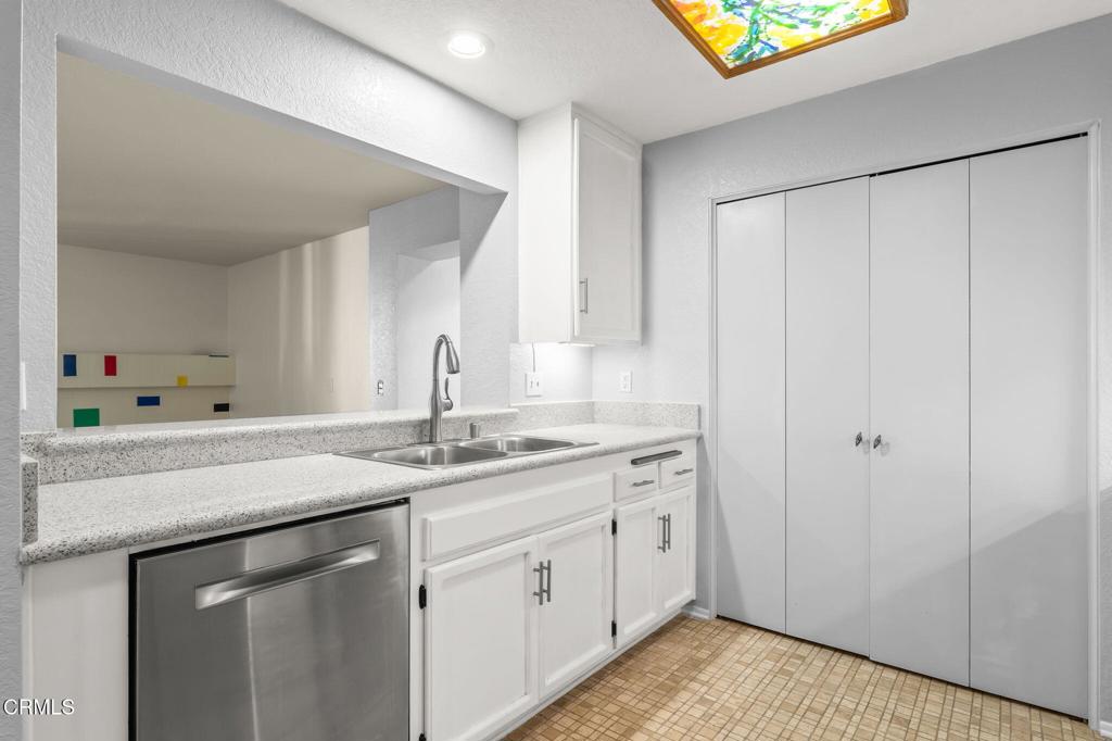 2202 Martinique Lane Oxnard, CA 93035 - Photo 16 of 39 a kitchen with a sink and cabinets