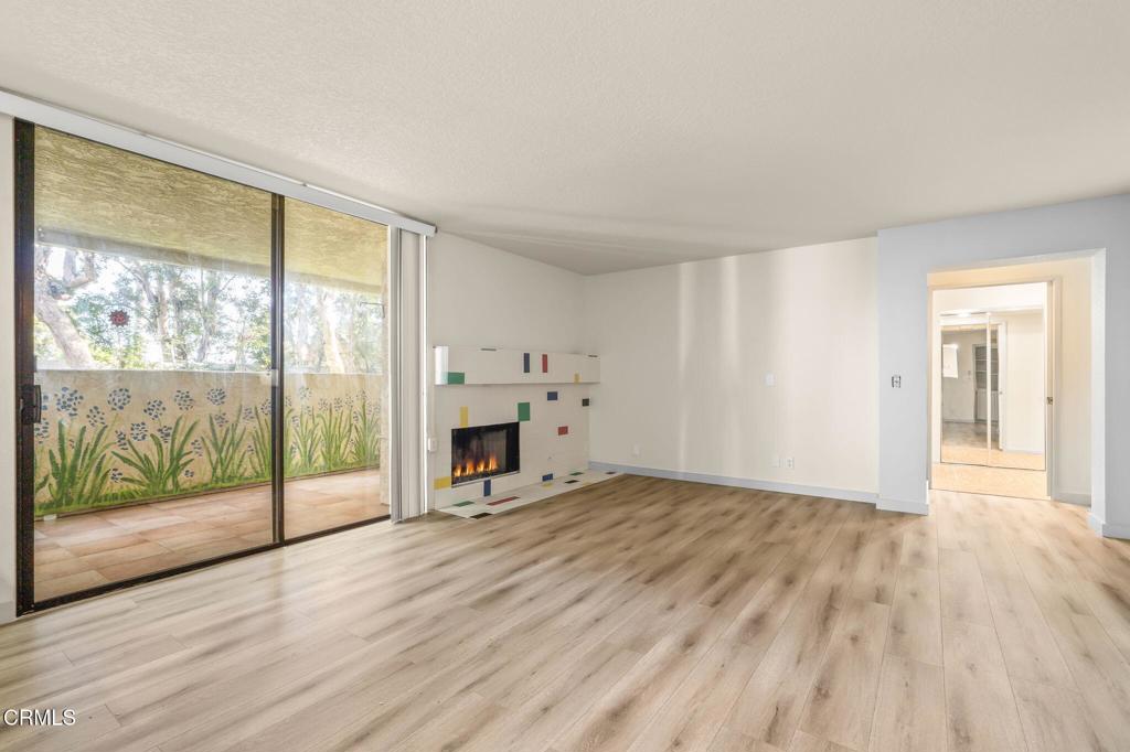 2202 Martinique Lane Oxnard, CA 93035 - Photo 9 of 39 a view of empty room with wooden floor and fireplace