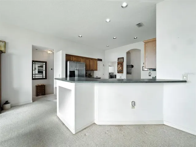 a view of kitchen with center island and stainless steel appliances