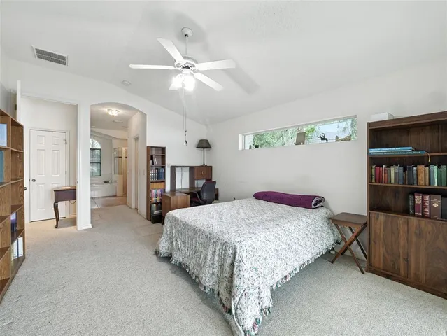 a bedroom with a bed furniture and a chandelier