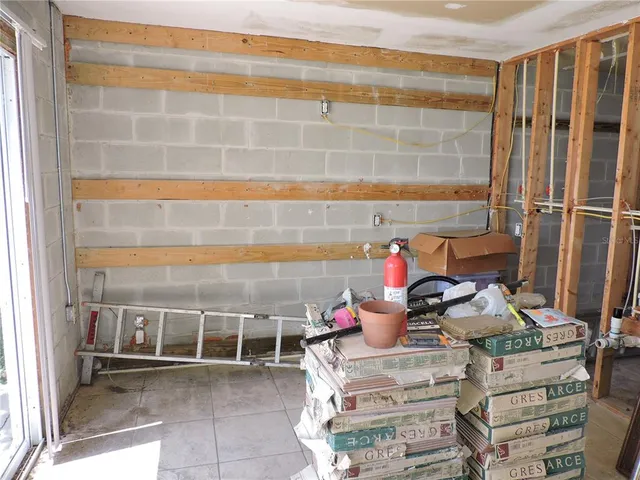 a view of a balcony with chairs and potted plants