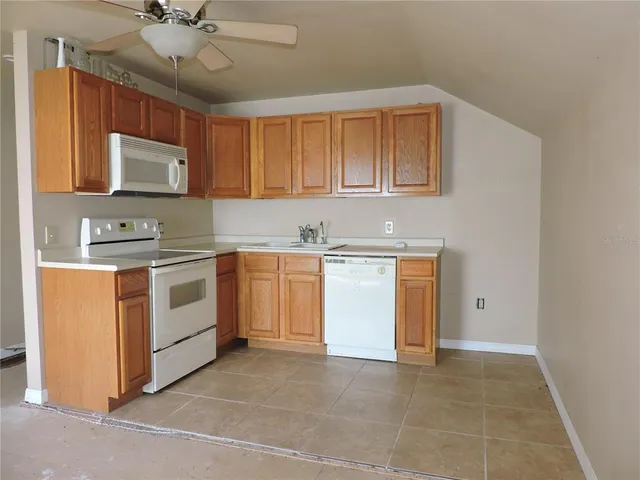 a kitchen with a stove sink and cabinets