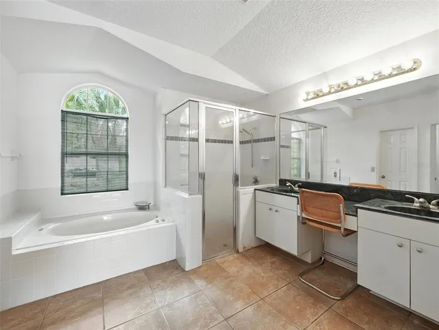 a bathroom with a tub sink and mirror