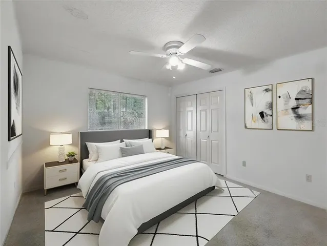 a bedroom with a large bed and a chandelier