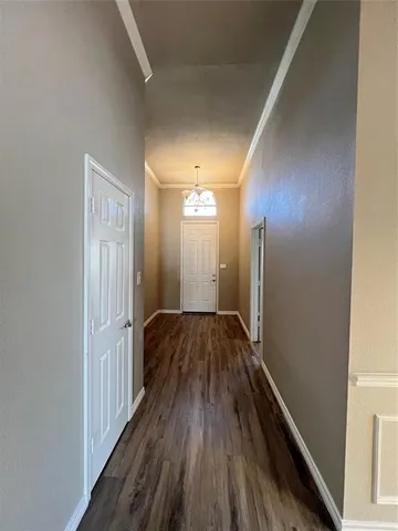 a view of hallway with wooden floor