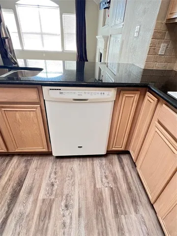 a view of a room with wooden floor and a sink