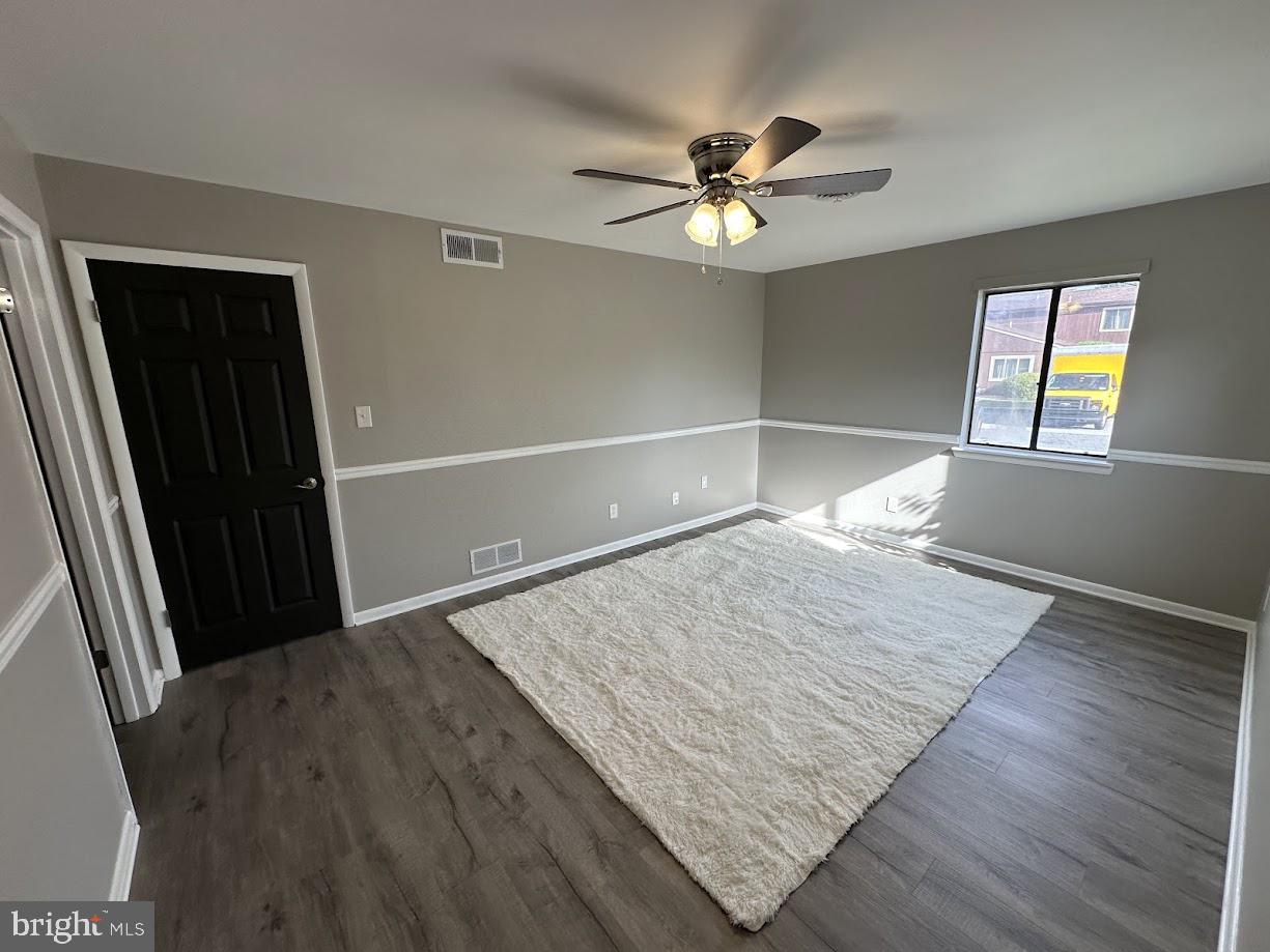 221 Lee Court Enola, PA 17025 - Photo 13 of 22 an empty room with wooden floor fan and windows