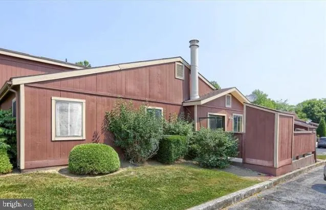 a view of a house with a yard and plants