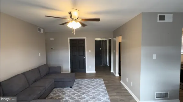 a living room with furniture and a rug