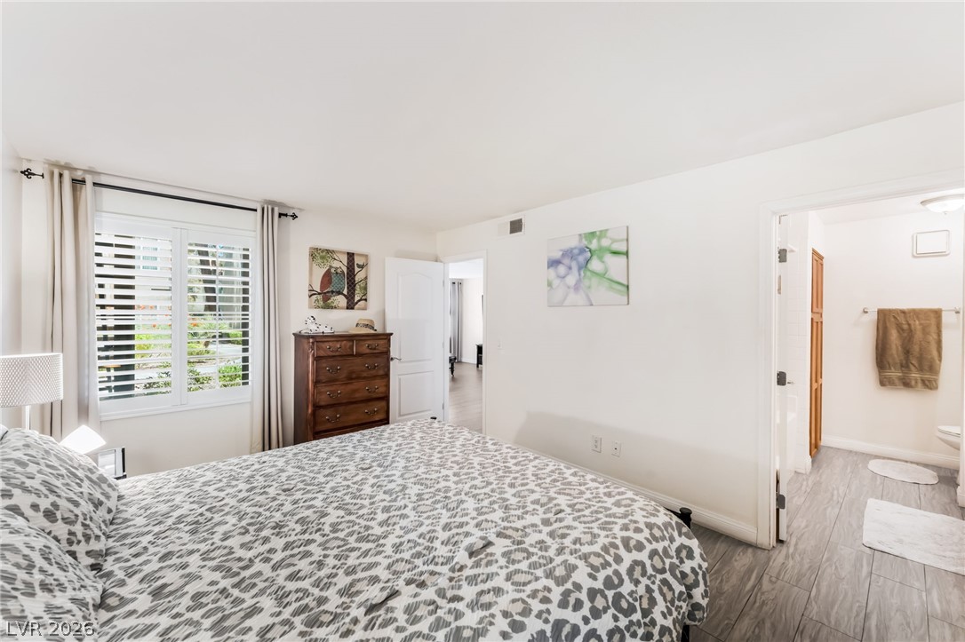 3145 East Flamingo Road, Unit 1092 Las Vegas, NV 89121 - Photo 14 of 33 Natural light streams through plantation shutters, illuminating this serene private retreat.