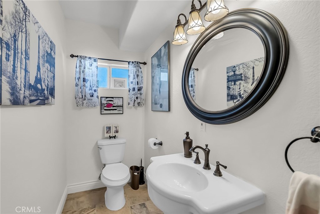 7384 Golden Star Avenue Riverside, CA 92506 - Photo 29 of 57 a bathroom with a toilet a sink and a mirror