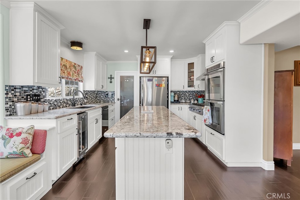 7384 Golden Star Avenue Riverside, CA 92506 - Photo 5 of 57 a kitchen with stainless steel appliances kitchen island granite countertop a refrigerator and a stove top oven
