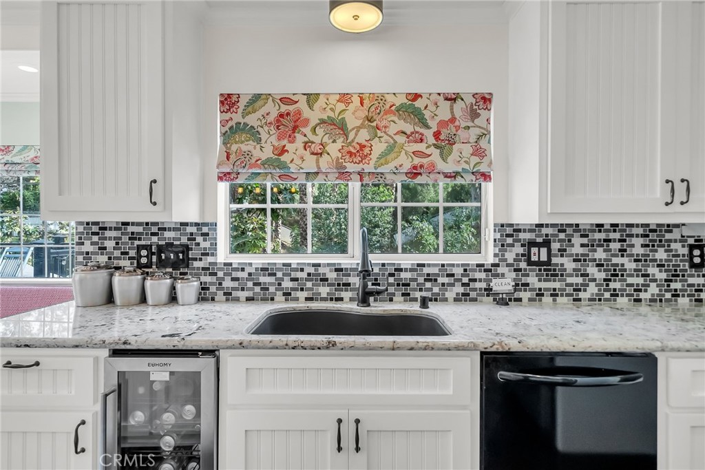 7384 Golden Star Avenue Riverside, CA 92506 - Photo 6 of 57 a kitchen with a sink a stove and cabinets