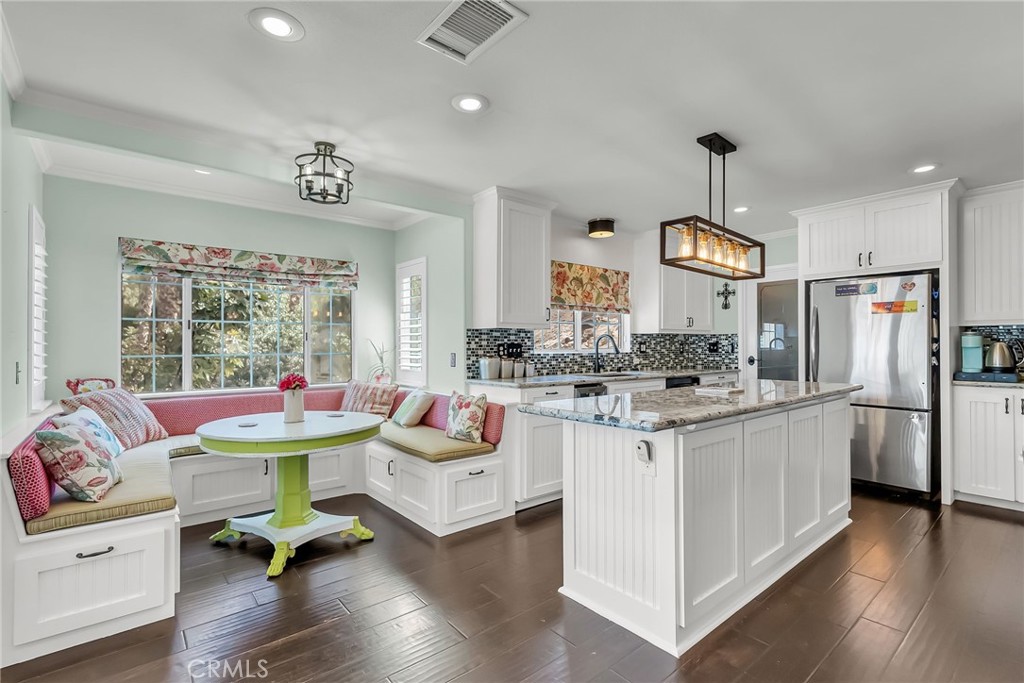7384 Golden Star Avenue Riverside, CA 92506 - Photo 8 of 57 a living room with stainless steel appliances kitchen island granite countertop furniture and a wooden floor