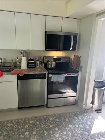 a kitchen with a stove and a microwave