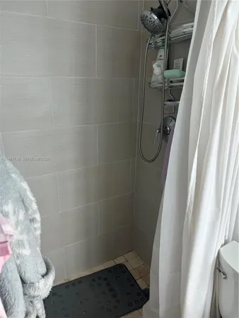 a bathroom with a glass shower door