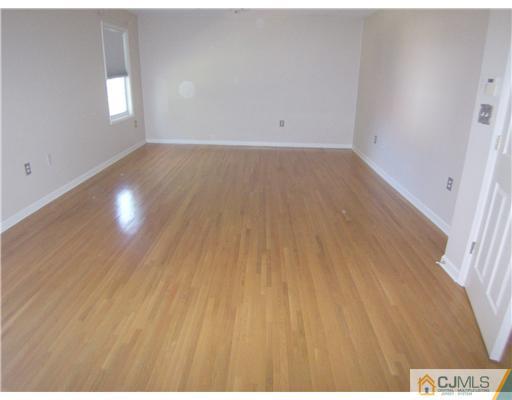 34 West Hill Road Colonia, NJ 07067 - Photo 12 of 25 a view of an empty room with wooden floor