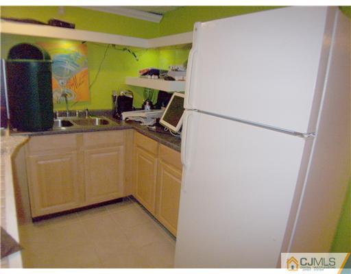 34 West Hill Road Colonia, NJ 07067 - Photo 21 of 25 a kitchen with a refrigerator and a stove