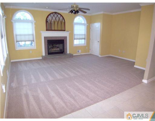 34 West Hill Road Colonia, NJ 07067 - Photo 7 of 25 a view of an empty room with a fireplace and a window