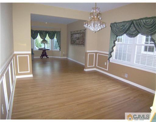34 West Hill Road Colonia, NJ 07067 - Photo 9 of 25 a view of a dining room with furniture a chandelier and wooden floor