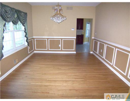 34 West Hill Road Colonia, NJ 07067 - Photo 10 of 25 a view of an empty room with a window and wooden floor