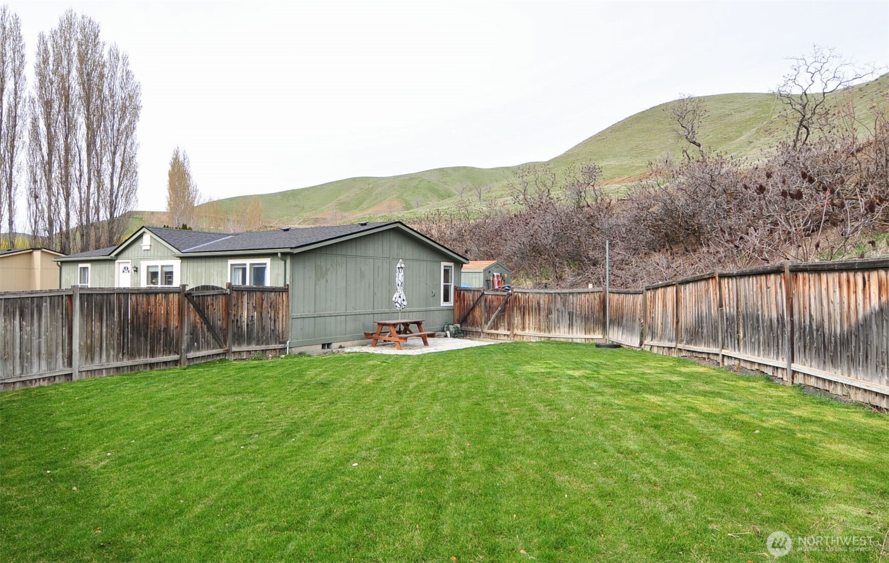 1698 Sunset Drive Wenatchee, WA 98801 - Photo 18 of 22 a view of backyard with wooden fence