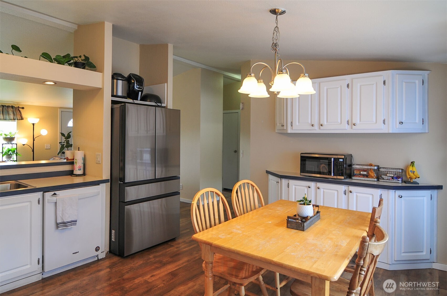 1698 Sunset Drive Wenatchee, WA 98801 - Photo 7 of 22 a kitchen with stainless steel appliances granite countertop a dining table chairs and refrigerator