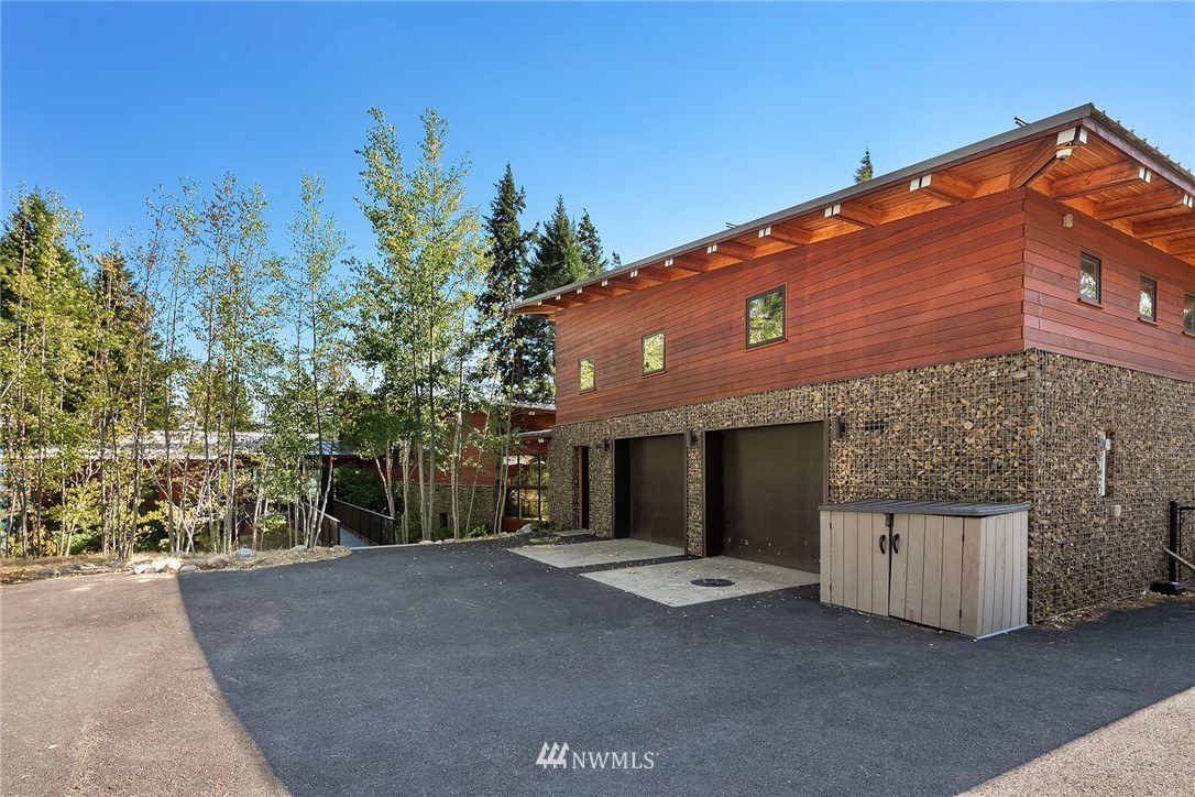 821 Timber Cove Drive Ronald, WA 98940 - Photo 33 of 40 a front view of a house with a yard and garage