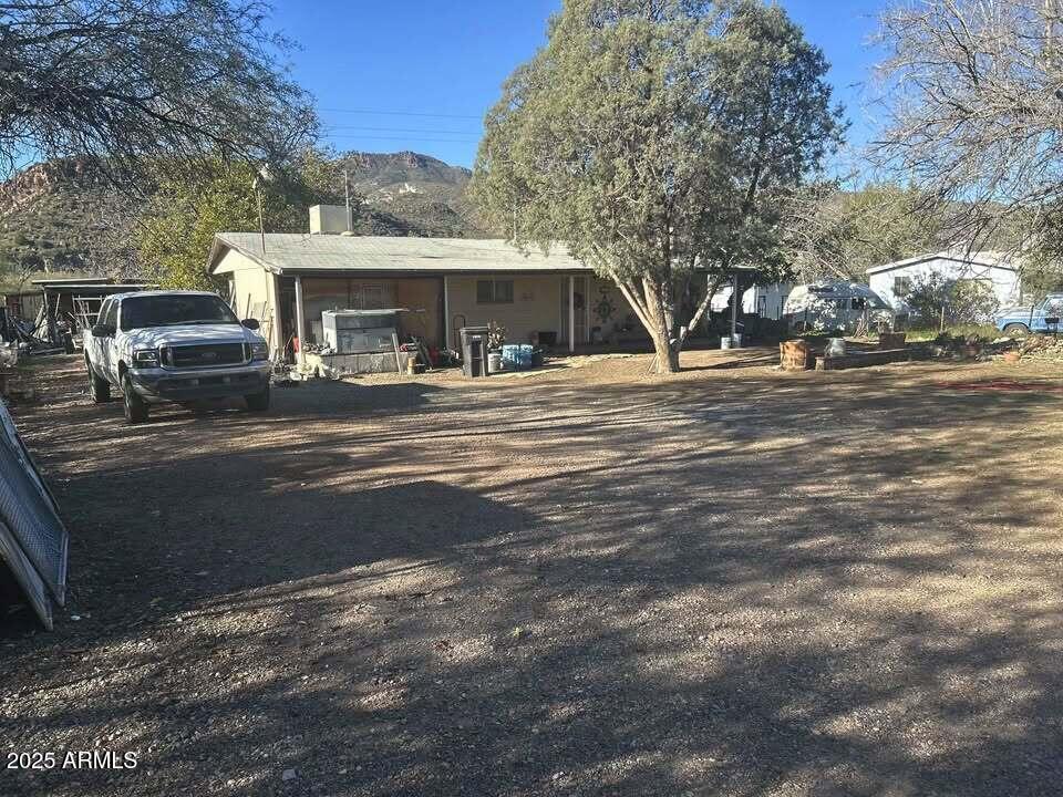 a view of house with outdoor space and car parked