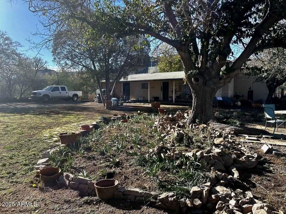 1954 North Bixby Road Globe, AZ 85501 - Photo 2 of 17 a view of a backyard with wooden fence and a large tree