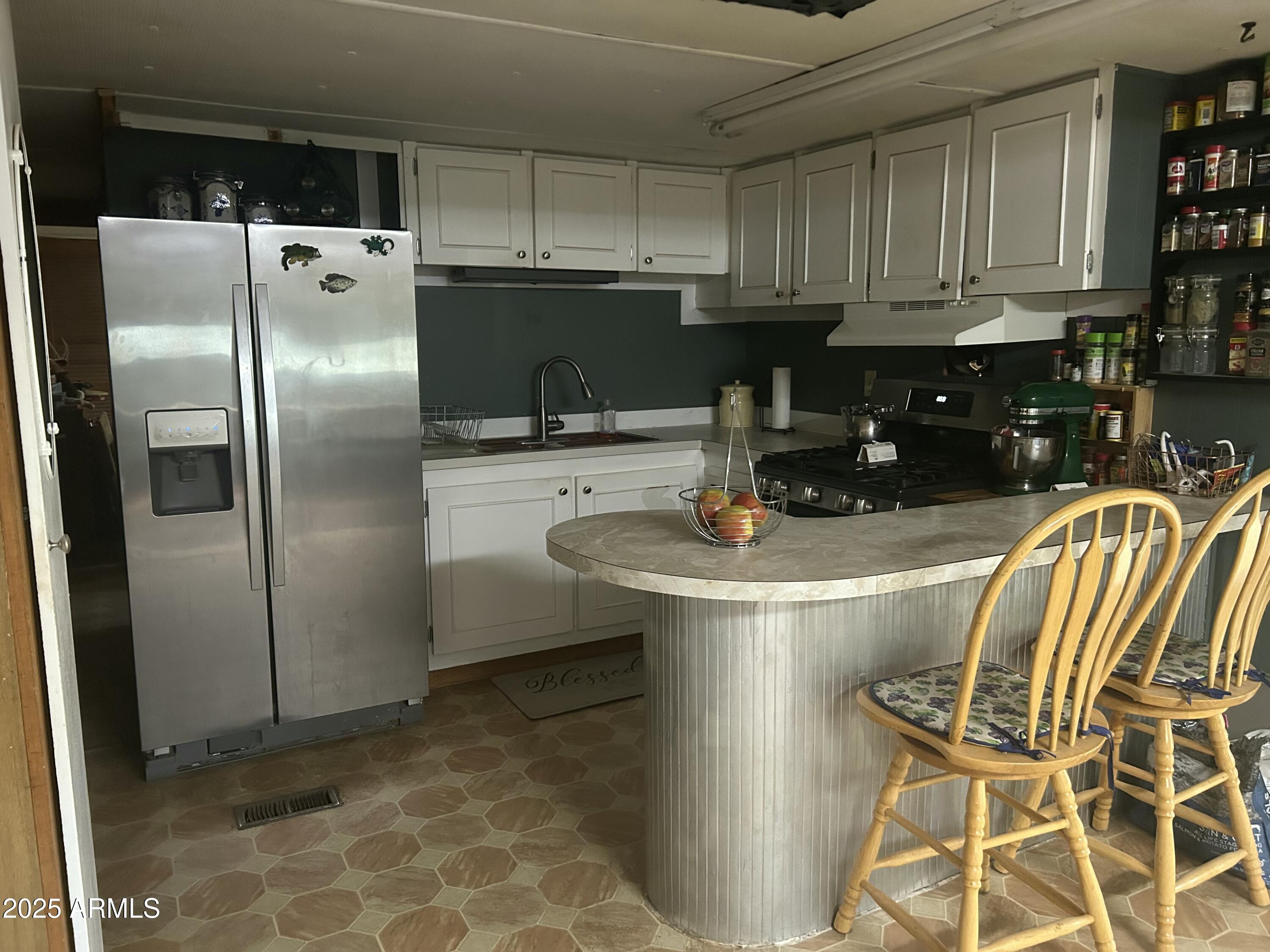 1954 North Bixby Road Globe, AZ 85501 - Photo 5 of 17 a kitchen with stainless steel appliances granite countertop a refrigerator a stove a sink and a stove