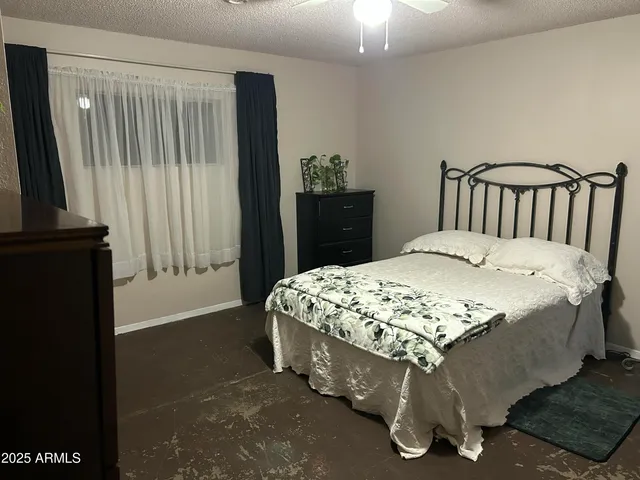 a bed sitting in a bedroom next to a window