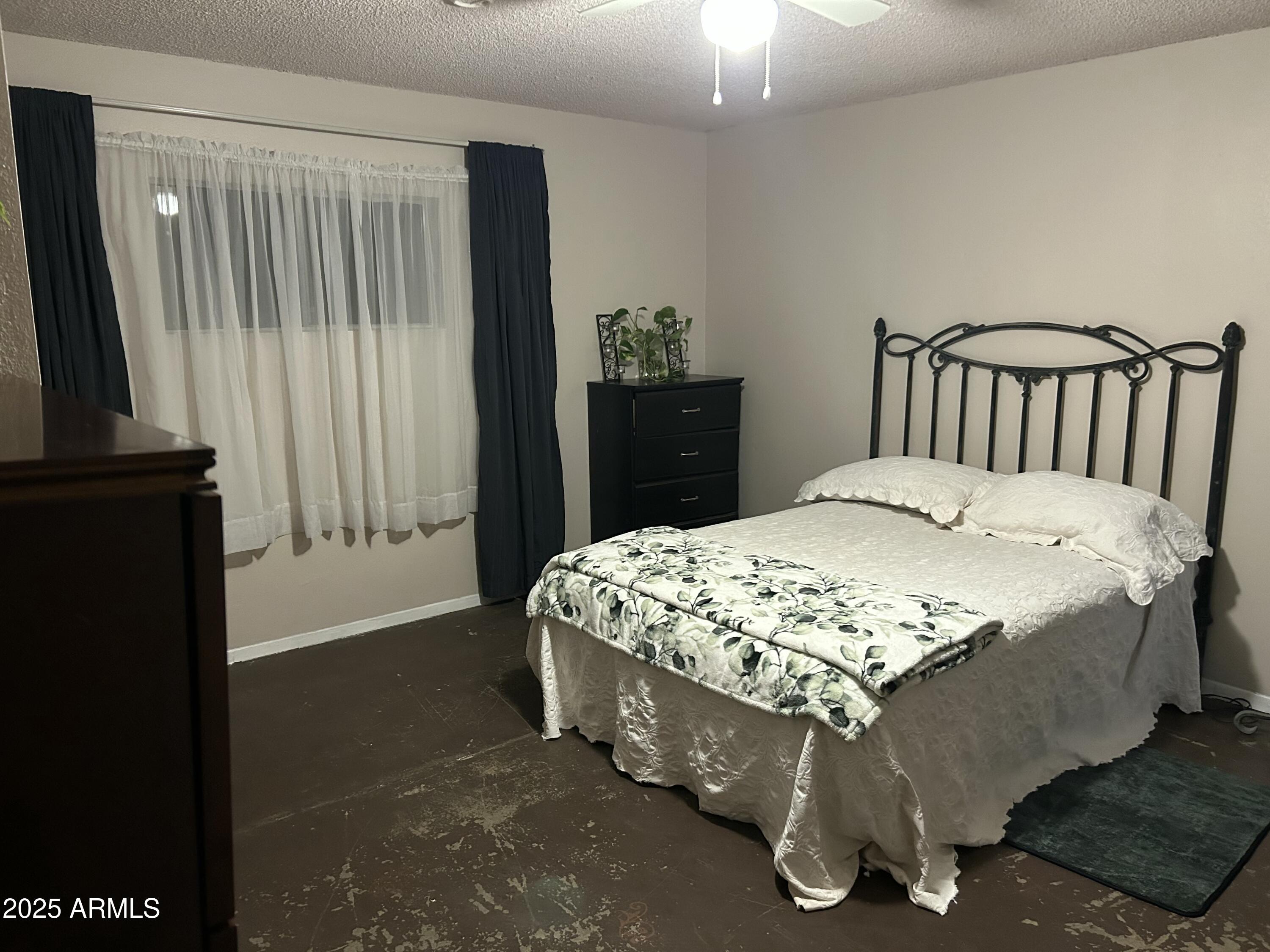 1954 North Bixby Road Globe, AZ 85501 - Photo 10 of 17 a bed sitting in a bedroom next to a window