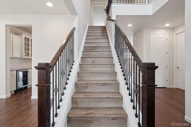 a view of entryway and hall with wooden floor