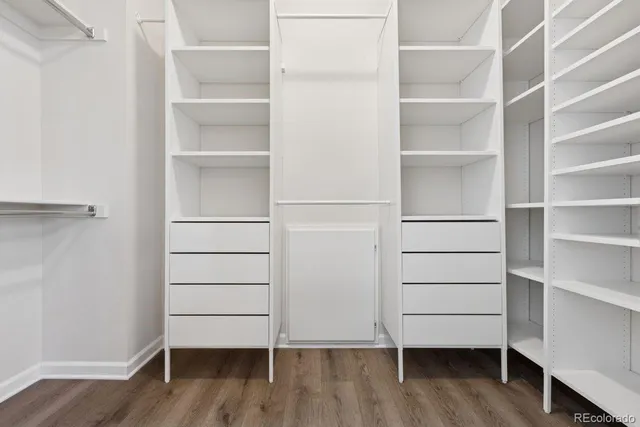 a view of walk in closet with empty racks