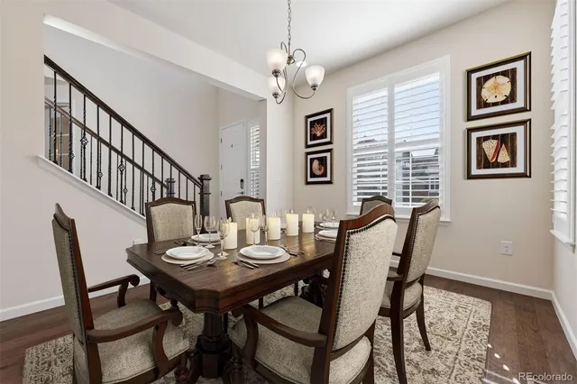 a view of a dining room with furniture and a chandelier