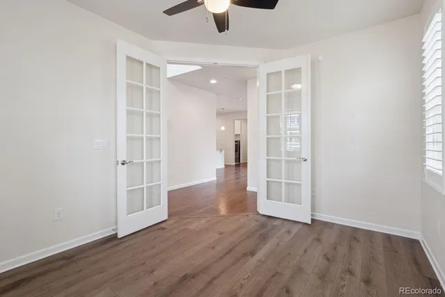 wooden floor in an empty room with a window