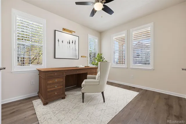 a view of a workspace with furniture and a window