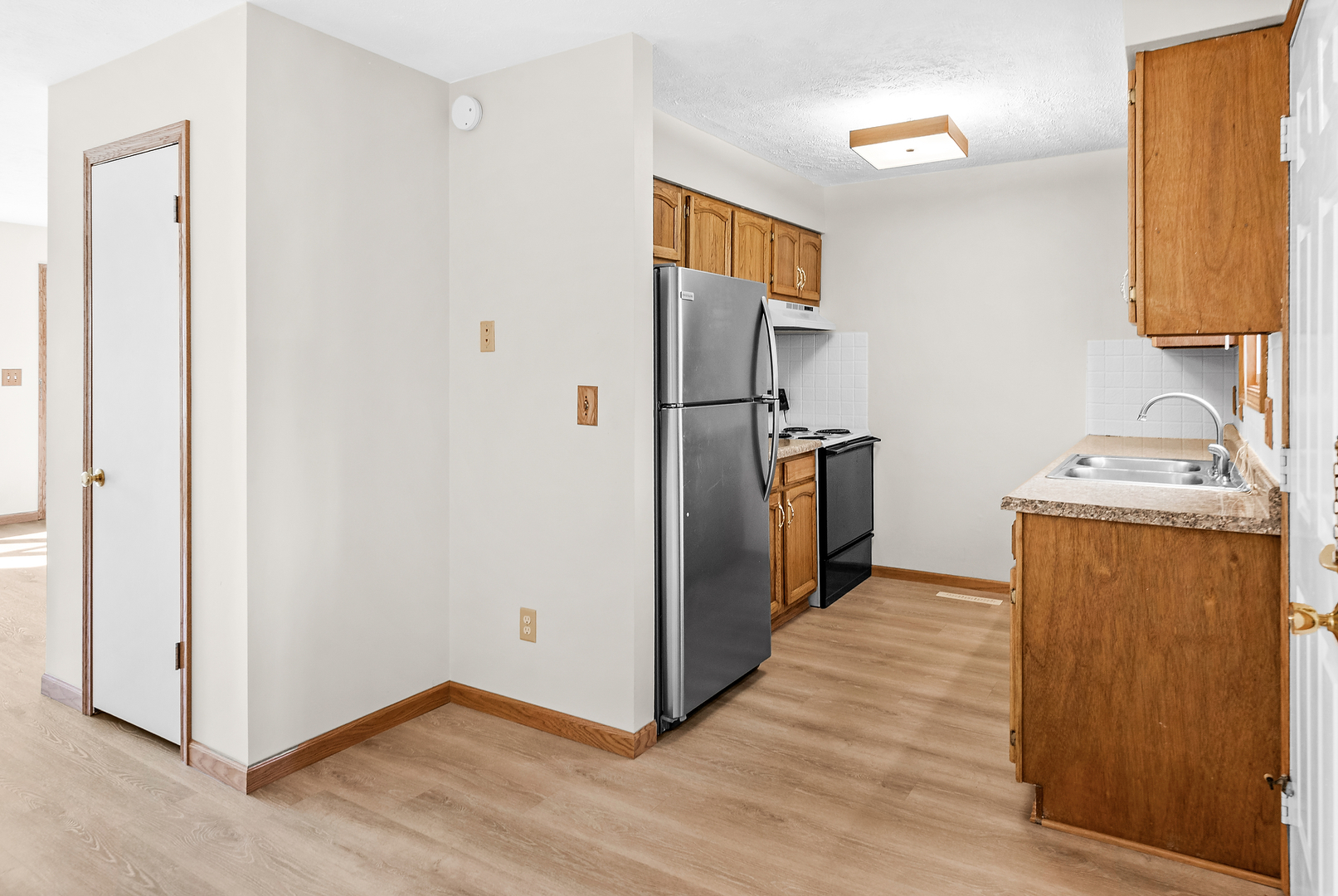 1402 Keller Road Normal, IL 61761 - Photo 13 of 30 a view of a kitchen with wooden floor and a sink