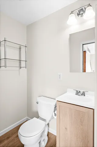 a white toilet sitting next to a bathroom sink