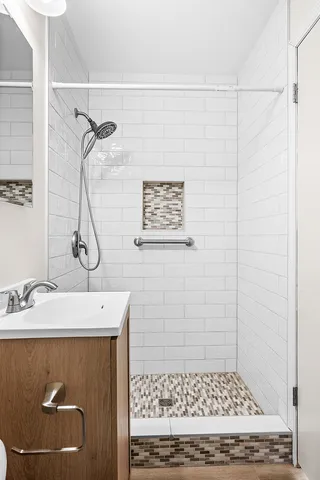 a bathroom with a sink a toilet and shower