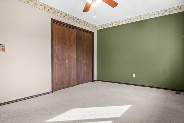 a view of a room with a ceiling fan and a window
