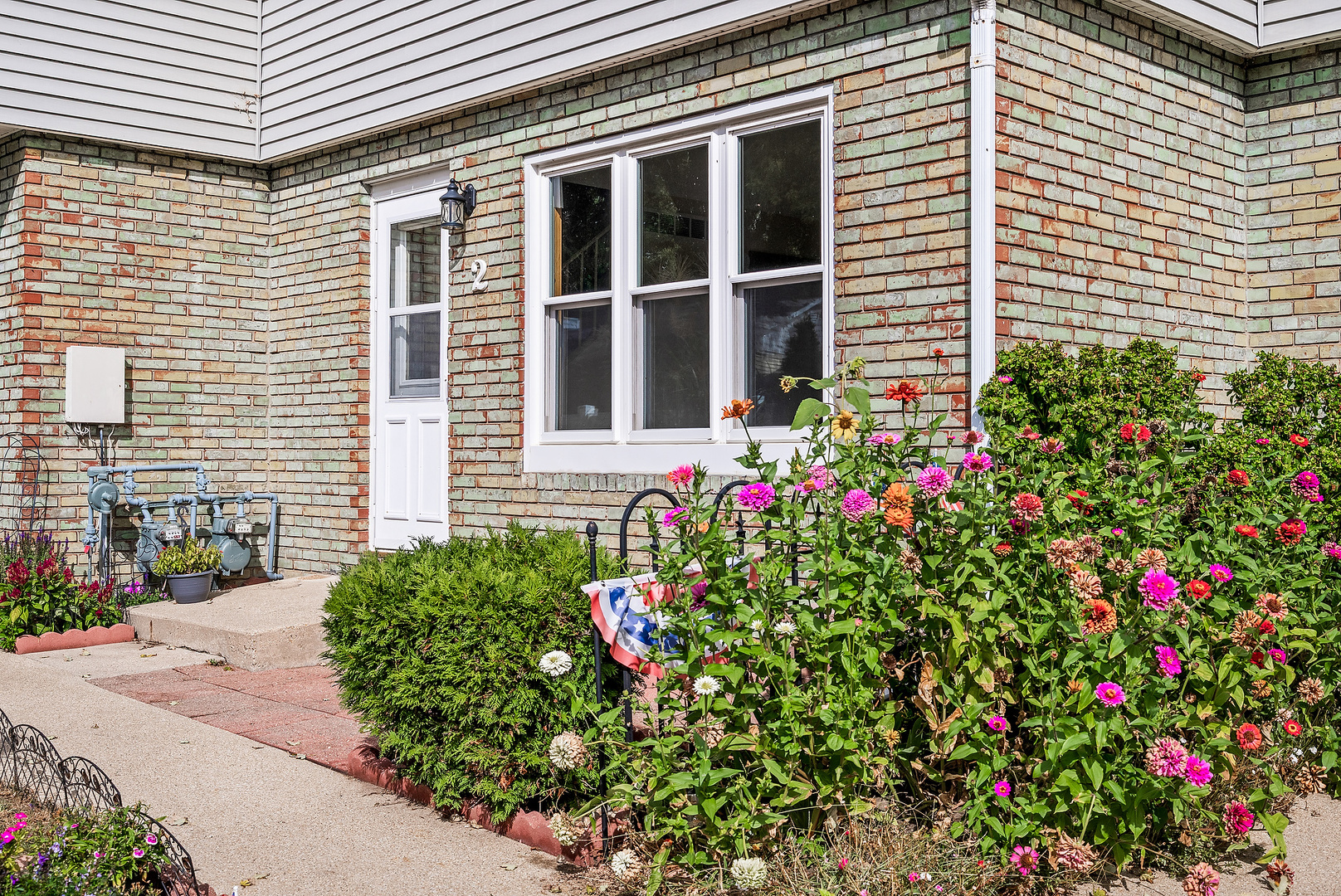 1402 Keller Road Normal, IL 61761 - Photo 3 of 30 a flower plants in front of a house