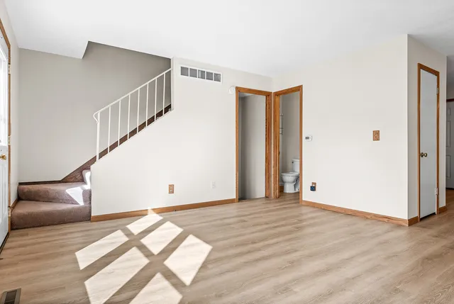 a view of entryway and hall with wooden floor